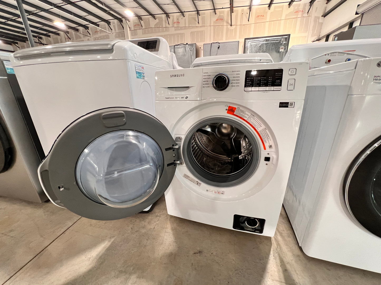 2.2 Cu. Ft. High Efficiency Stackable Front Load Washer with Steam( missing bottom access panel)